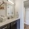 a bathroom with a vase and a plant on the counter