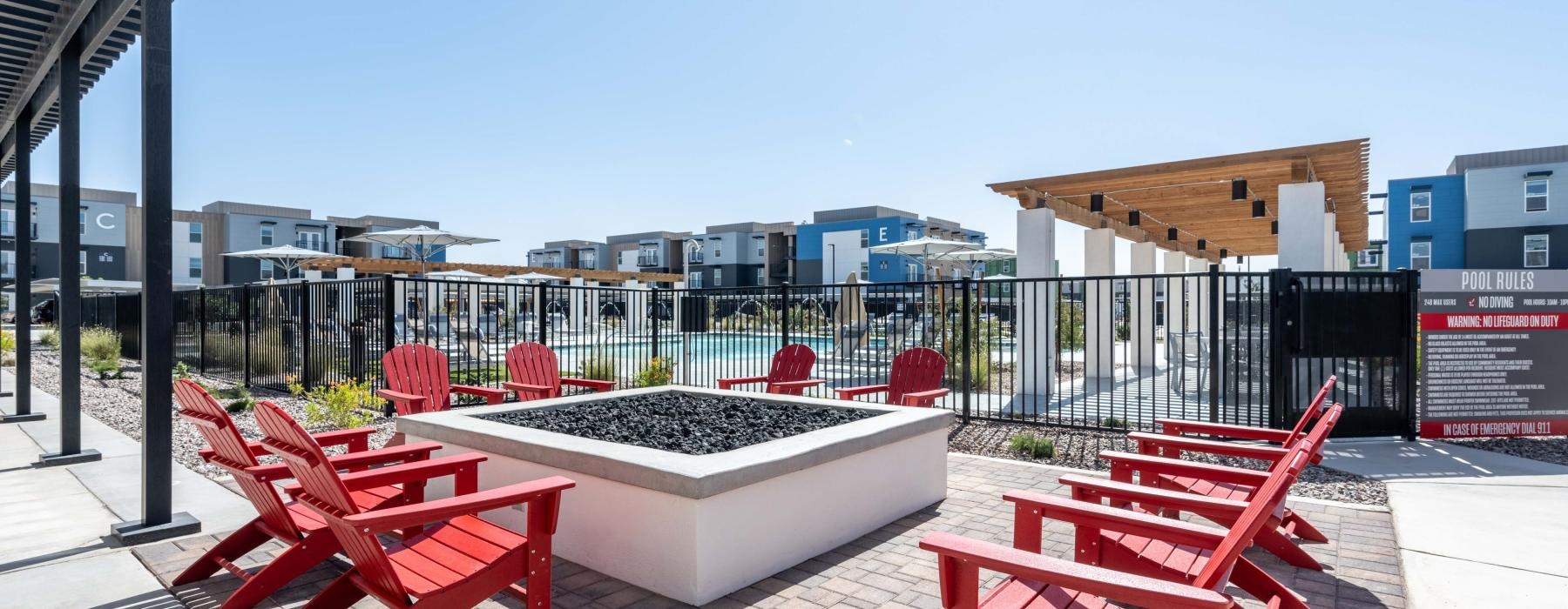 a group of red benches on a brick patio