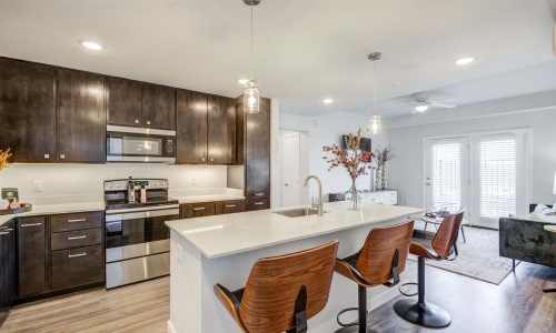 spacious interiors of a kitchen leading into the living room area